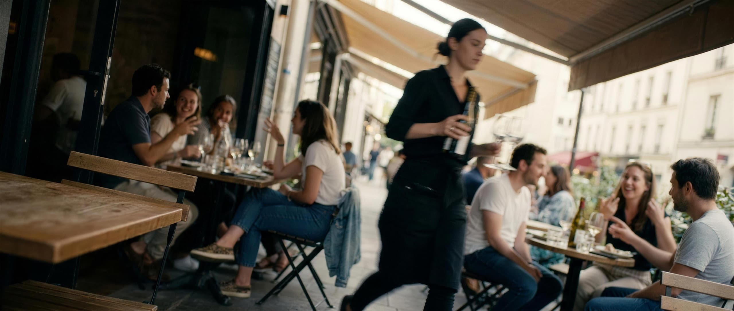A lively sidewalk wine bar patio on a good night out